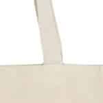 Gros plan sur la bandoulière et la partie supérieure d'un Totebag épais écru (280g/m2), mettant en valeur des coutures détaillées sur la toile de couleur naturelle.