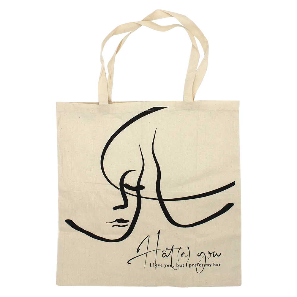 Un sac fourre-tout beige avec un dessin au trait minimaliste d'un visage et le texte : 
